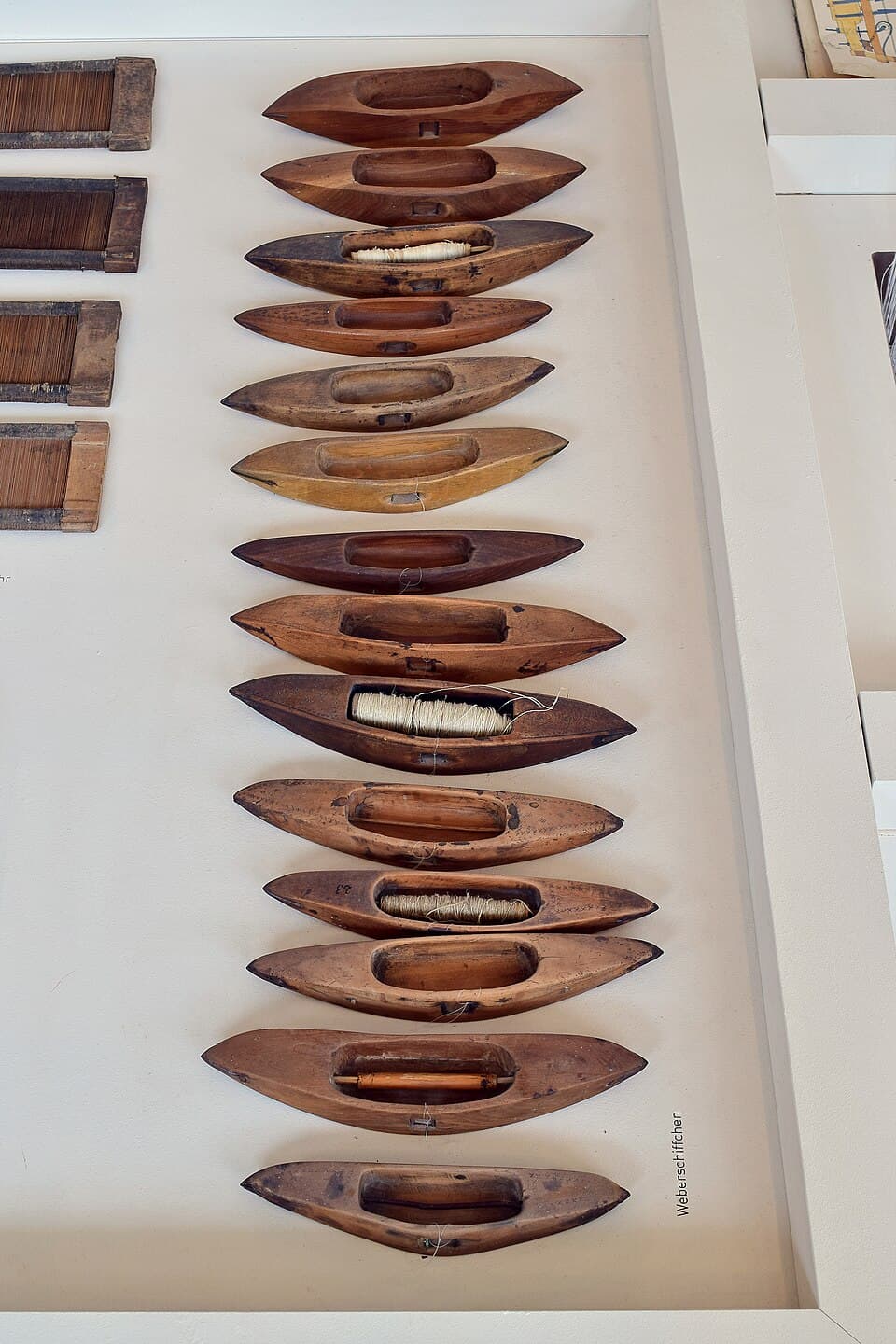 A shuttle that carries the weft across the loom.